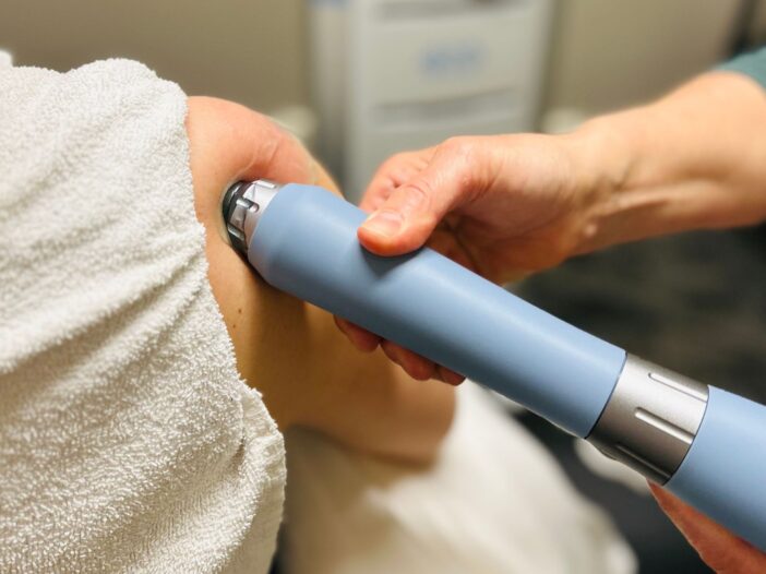 Physiotherapy patient receiving extracorporeal shockwave therapy at Moveo Physio in Orleans, Ottawa, Ontario
